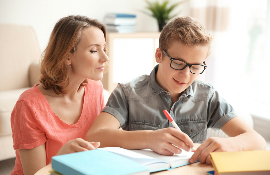 mom calmly teaching her teen with assignment