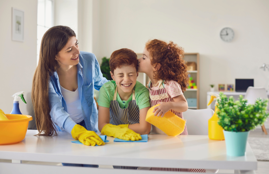 Happy family washingthe table with detergents