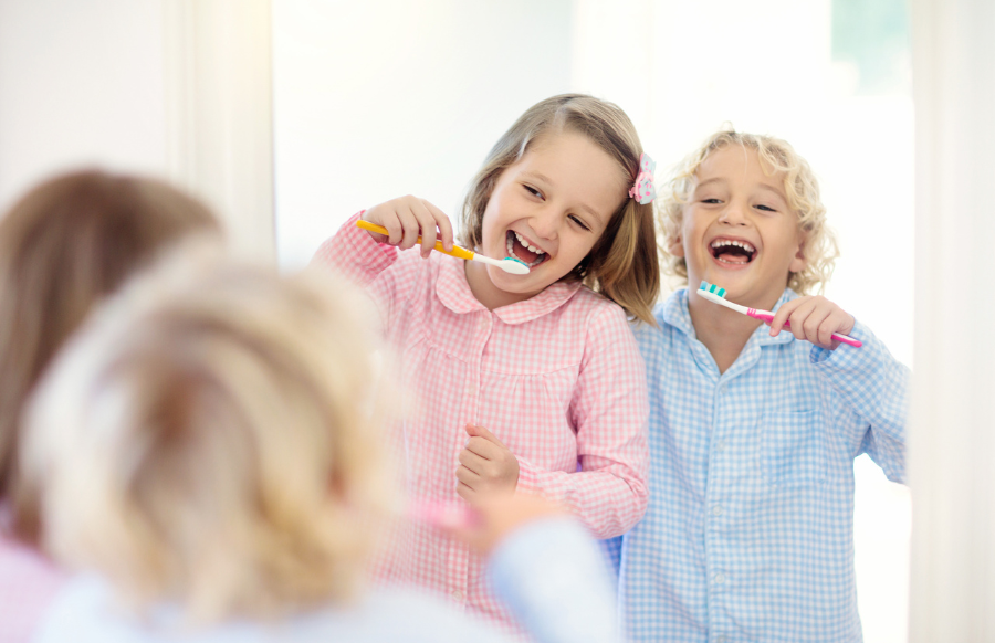 kids brushing teeth happily