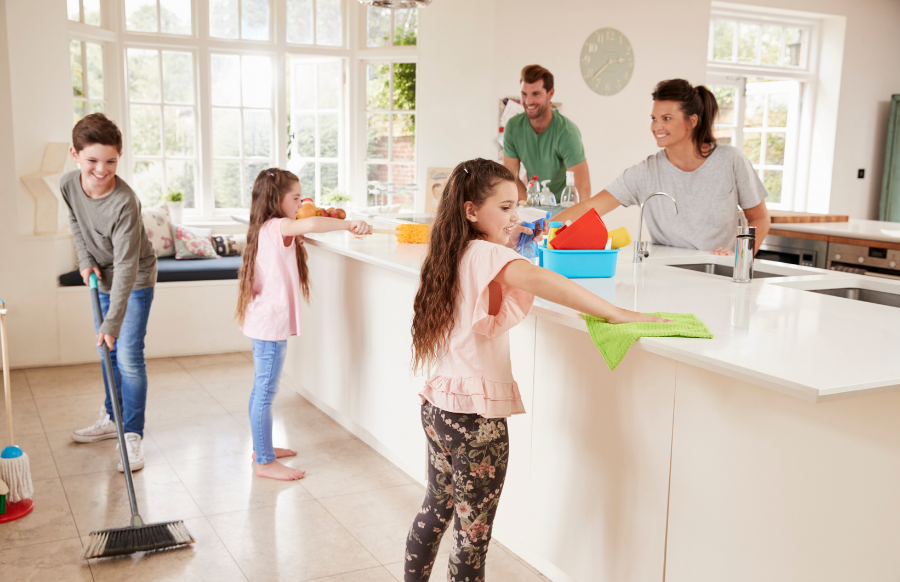 children helping parents with household chores in kitchen  