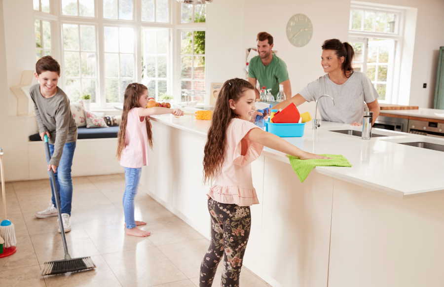 children helping parent with household chores in kitchen