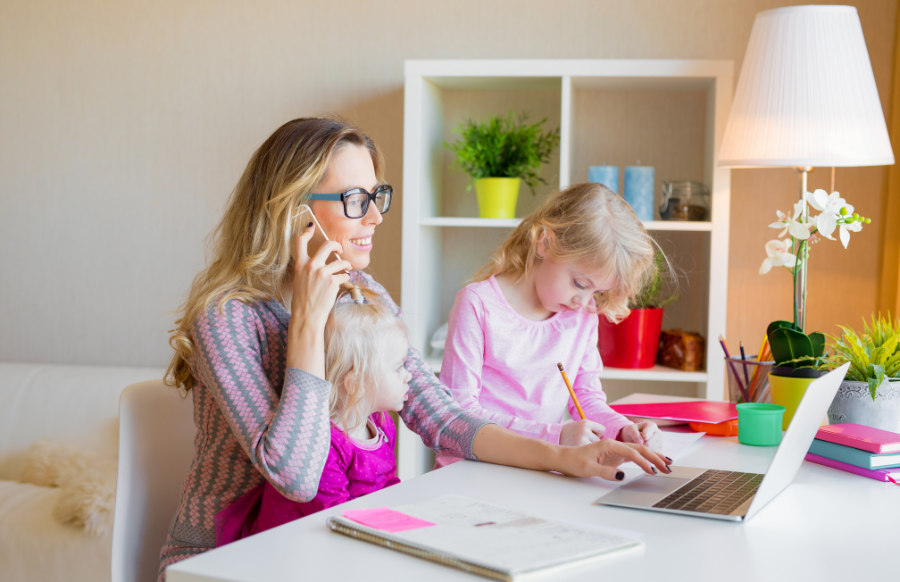 mom with daughters working from home